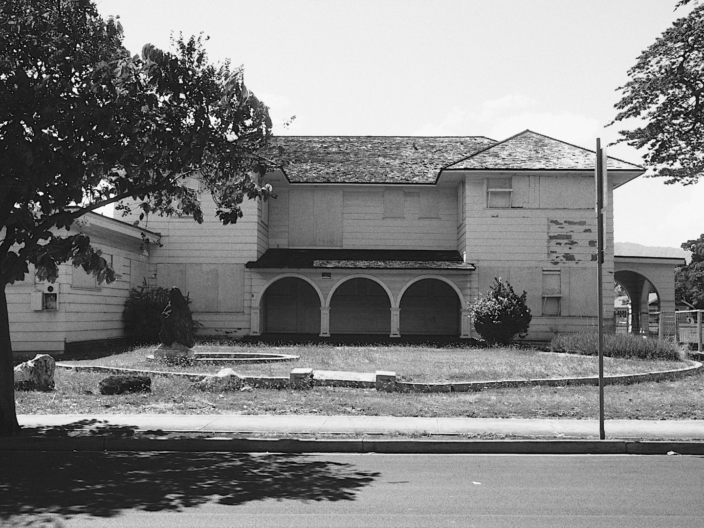 A white two storey house with arches, in black and white with Ilford FP4 Plus 125.